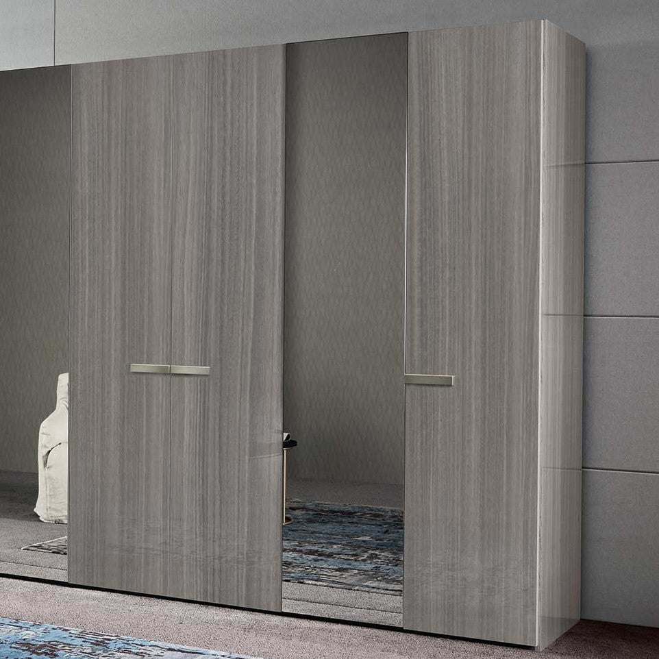 A large, modern sliding door wardrobe with light wood grain finishes and central mirrored panels. — Castle Furniture