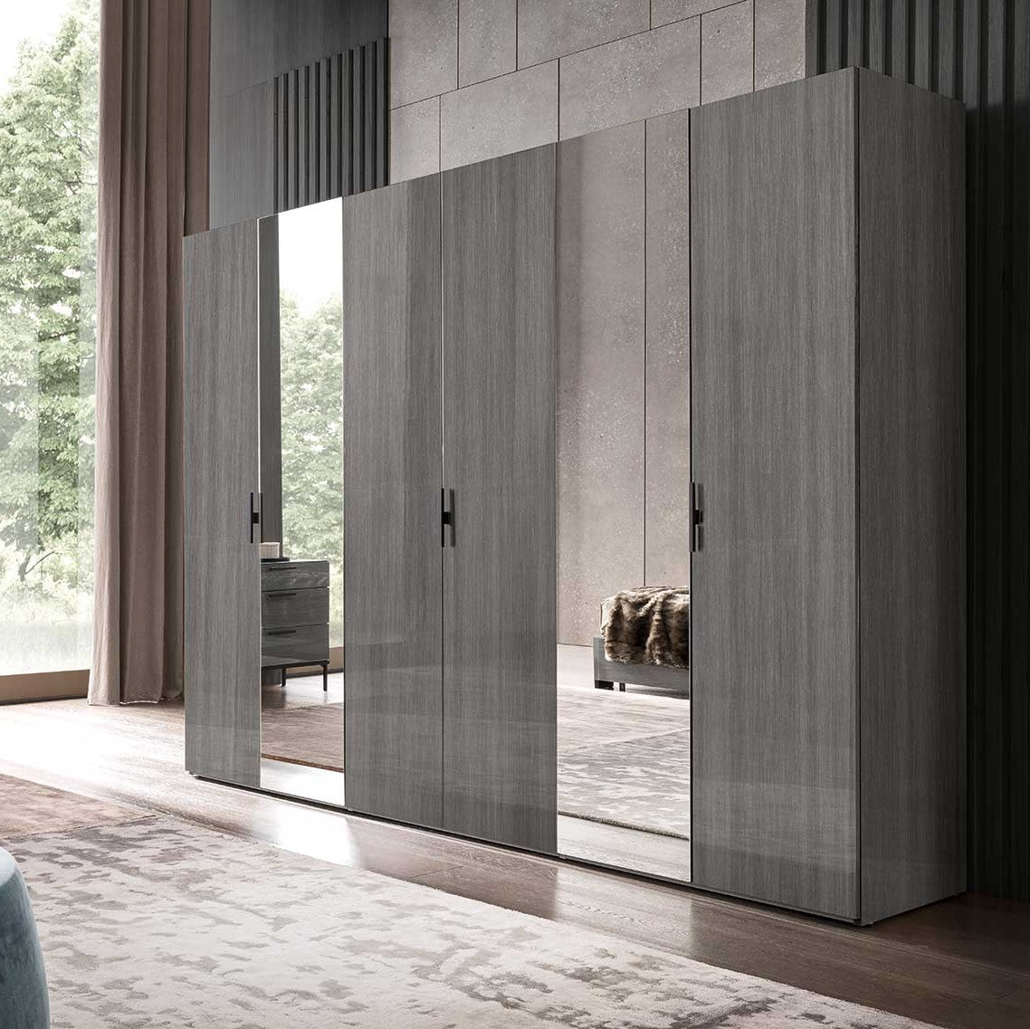 A large modern grey wooden wardrobe with mirrored doors and black handles stands in a contemporary bedroom. — Castle Furnitur