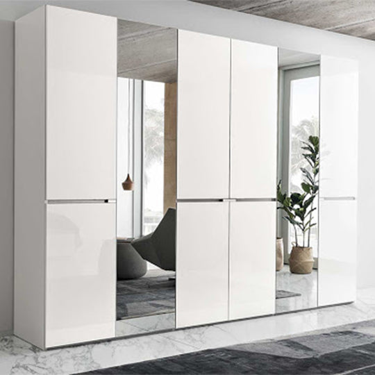 A modern, high-gloss white wardrobe with large mirrored panels set against a marble floor in a bright room. — Castle Furnitur